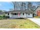 Charming single-story home with a welcoming front porch and well-maintained lawn at 1830 Jan Hill Ne Ln, Atlanta, GA 30329