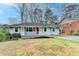 Charming single-story home with a welcoming front porch and well-maintained lawn at 1830 Jan Hill Ne Ln, Atlanta, GA 30329