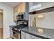 Updated kitchen features stainless steel appliances, granite counters, and light wood cabinets at 1830 Jan Hill Ne Ln, Atlanta, GA 30329