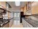 Well-lit kitchen with granite countertops, mosaic backsplash, stainless steel appliances, and wood cabinets at 1830 Jan Hill Ne Ln, Atlanta, GA 30329