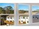 Bright view of townhomes with a wood deck and a blue sky peeking from behind the trees at 316 Oldvine Dr, Lawrenceville, GA 30044