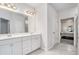 Bright bathroom featuring double vanity sinks, a large mirror and tile floors at 3901 Shelleydale Dr, Powder Springs, GA 30127