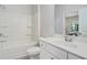 Bathroom with white tiled shower-tub combo and single vanity at 3901 Shelleydale Dr, Powder Springs, GA 30127