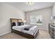 Carpeted bedroom featuring a queen bed and a dark wood dresser at 3901 Shelleydale Dr, Powder Springs, GA 30127