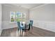 Bright dining area with wood floors, classic wainscoting, light walls, and large windows at 3901 Shelleydale Dr, Powder Springs, GA 30127