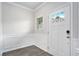 Bright entryway with white trim, wood-look floors and door with window insert at 3901 Shelleydale Dr, Powder Springs, GA 30127
