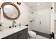 This modern bathroom has a walk-in shower with subway tile and black accents at 9229 Selborne Ln, Chattahoochee Hills, GA 30268