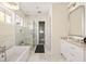 Elegant bathroom showcasing a glass-enclosed shower, soaking tub, and marble countertops at 9229 Selborne Ln, Chattahoochee Hills, GA 30268