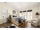 Comfortable bedroom featuring natural light, hardwood floors, and relaxed decor at 9229 Selborne Ln, Chattahoochee Hills, GA 30268