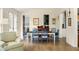 Bright dining room with hardwood floors, and seating for six at 9229 Selborne Ln, Chattahoochee Hills, GA 30268
