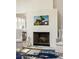 Living room fireplace featuring white painted brick and decorative mantle at 9229 Selborne Ln, Chattahoochee Hills, GA 30268