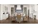Eat-in kitchen features white cabinets, custom backsplash, and stainless appliances overlooking an oversized island at 9229 Selborne Ln, Chattahoochee Hills, GA 30268