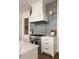 Chef's kitchen featuring stainless steel appliances and gray tile backsplash at 9229 Selborne Ln, Chattahoochee Hills, GA 30268