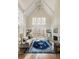Bright living room featuring high ceilings, large windows, and a cozy fireplace with hardwood flooring at 9229 Selborne Ln, Chattahoochee Hills, GA 30268