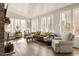 Bright living room featuring hardwood floors and multiple windows at 9229 Selborne Ln, Chattahoochee Hills, GA 30268