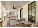 Inviting covered porch with a swing, ceiling fan, and comfortable seating area perfect for relaxation at 9229 Selborne Ln, Chattahoochee Hills, GA 30268