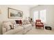 A bright sitting room features a comfortable couch with decorative pillows at 9229 Selborne Ln, Chattahoochee Hills, GA 30268