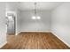 A dining room with wood-look flooring and a modern chandelier at 18201 Waldrop Cv, Decatur, GA 30034