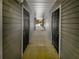 A exterior hallway to a gated apartment door features lots of doors and covered corridor at 18201 Waldrop Cv, Decatur, GA 30034