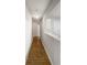 A hallway with neutral walls and wood-look flooring at 18201 Waldrop Cv, Decatur, GA 30034