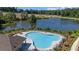 An aerial view of a luxurious community pool near a lake with lounge seating and umbrellas at 2732 Harrison Dr, Lawrenceville, GA 30044