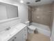 Well-lit bathroom with white vanity, modern sink, shower and tub combination with neutral tile surround at 3085 Colonial Way # G, Atlanta, GA 30341