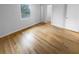 Bedroom featuring gleaming hardwood floors, a closet, and a window providing natural light at 3085 Colonial Way # G, Atlanta, GA 30341