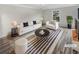 Bright living room featuring a modern sofa, chair, and striped area rug at 3085 Colonial Way # G, Atlanta, GA 30341