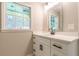 A well-lit bathroom featuring quartz vanity and decorative mirror at 313 Linda Dr, Tucker, GA 30084