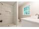 A bright bathroom featuring tiled shower and modern vanity at 313 Linda Dr, Tucker, GA 30084