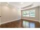 Bedroom featuring tray ceilings, hardwood floors, recessed lighting, and double hung windows overlooking the yard at 313 Linda Dr, Tucker, GA 30084