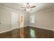 A primary bedroom featuring hardwood floors, neutral paint, and a large window at 313 Linda Dr, Tucker, GA 30084