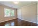 Bedroom features hardwood floors, large windows, and a closet at 313 Linda Dr, Tucker, GA 30084