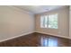 Bright bedroom with hardwood floors, large windows, and neutral wall color at 313 Linda Dr, Tucker, GA 30084