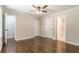 A primary bedroom featuring hardwood floors, neutral paint, ceiling fan, and ensuite bath at 313 Linda Dr, Tucker, GA 30084