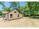 An exterior view of home featuring green grass and mature trees at 313 Linda Dr, Tucker, GA 30084