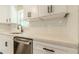 Close-up of kitchen detailing quartz countertops, stainless steel dishwasher, and white subway tile backsplash at 313 Linda Dr, Tucker, GA 30084