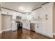 Bright kitchen featuring white cabinets, stainless steel appliances, quartz countertops, and dark hardwood floors at 313 Linda Dr, Tucker, GA 30084