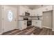 A bright kitchen featuring white cabinets, stainless appliances, and laminate floors at 313 Linda Dr, Tucker, GA 30084