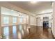 Open-concept living room with dark hardwood floors, white trim, and adjacent kitchen with stainless steel appliances at 313 Linda Dr, Tucker, GA 30084