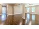 Spacious living room with dark hardwood floors, neutral paint, white trim, and open doorway to another room at 313 Linda Dr, Tucker, GA 30084