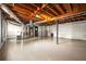 Unfinished basement space with painted floor and open ceiling at 3875 Wisteria Lane Southwest Sw Ln, Atlanta, GA 30331