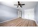 This spacious bedroom features wood-look flooring, fresh paint, a ceiling fan, and ample closet space at 3875 Wisteria Lane Southwest Sw Ln, Atlanta, GA 30331