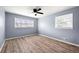 Bright bedroom with wood-look flooring, fresh paint, and windows that bring in plenty of natural light at 3875 Wisteria Lane Southwest Sw Ln, Atlanta, GA 30331