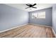 Bedroom featuring wood floors, a ceiling fan, and two windows at 3875 Wisteria Lane Southwest Sw Ln, Atlanta, GA 30331