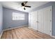 Bedroom featuring wood floors, a ceiling fan, and a double door closet at 3875 Wisteria Lane Southwest Sw Ln, Atlanta, GA 30331