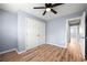 Bedroom featuring wood floors, a ceiling fan, and a double door closet at 3875 Wisteria Lane Southwest Sw Ln, Atlanta, GA 30331