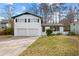 Charming two-story painted brick home features a lush front yard and attached two-car garage at 3875 Wisteria Lane Southwest Sw Ln, Atlanta, GA 30331