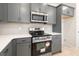 Well-equipped kitchen featuring gray cabinets, stainless steel appliances, and ample counter space, perfect for culinary enthusiasts at 735 Shetland Trl, Cartersville, GA 30121