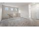 Carpeted loft area showcasing a wooden banister and natural light from the windows at 735 Shetland Trl, Cartersville, GA 30121